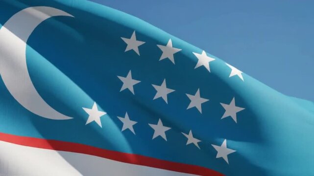 National flag of uzbekistan waving in the wind against a clear blue sky