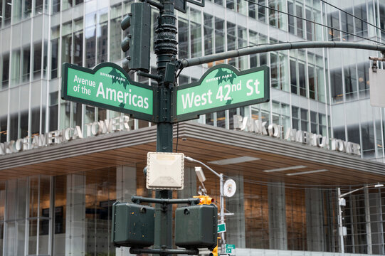 New York, New York USA - June 6, 2026: Street signs at the corner of 6th Avenue and West 42nd street. Bank of America in the backgournd.