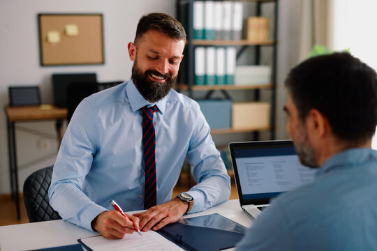 Manager signing contract document during a job interview