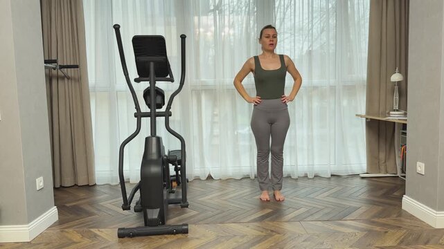 Female athlete performs multiple repetitions of forward toe touches in structured sets. Home workout for stretching legs and improving flexibility and endurance.
