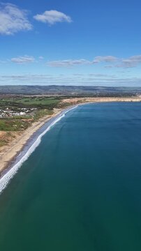 Maslin Beach, South Australia &ndash; 4K aerial drone footage of coastal cliffs, sandy beach, turquoise ocean, suburban homes, modern housing estates, scenic coastline, seaside landscapes in South Adelaide