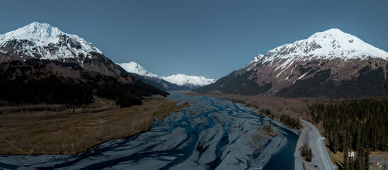 Alaskan Landscape: Snow-Capped Peaks and Winding River © Adi