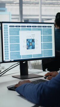 Vertical Video Technician in microchip factory R&D workspace optimizing production with PC software.