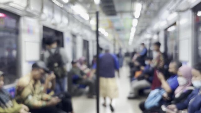 Defocused footage of passengers boarding a commuter train at a station platform, representing public transportation, mobility, and urban commuting.