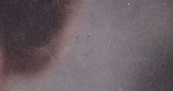 transparent strong glass on a black uneven background, the glass is strong but with scuffs and minor defects