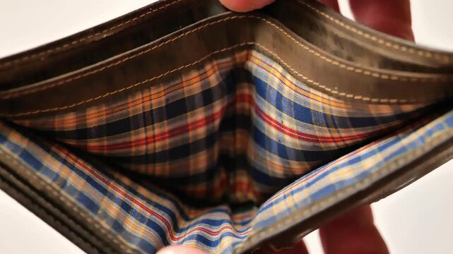 Budget deficit and poverty concept.mans hands open an empty wallet against a light background. 4k footage
