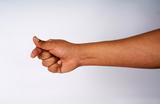 Hand making a fig sign gesture isolated on white background
