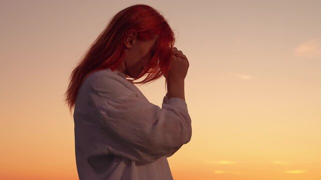 Girl confesses. Christian woman praying sunset, close-up. Faith God. Woman prays family children against backdrop sky sun. Relaxation meditation nature. Apologizing. Hope. People religion. Silhouette