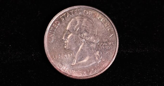   quarter dollar   on a black velvet cloth, one damaged 25-cent coin covered with yellow rust and plaque, close up