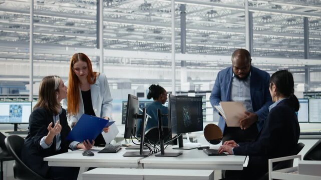 Diverse men assessing substrates quality using AI LLM, senior manager and worker studying silicon wafer helped by AI assistant, for semiconductor research, for microchip development.