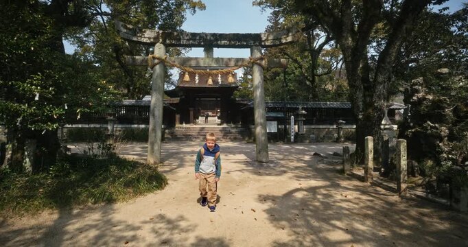Child Walking Along Sandy Path at Ancient Japanese Shinto Shrine, Steady Cam movement