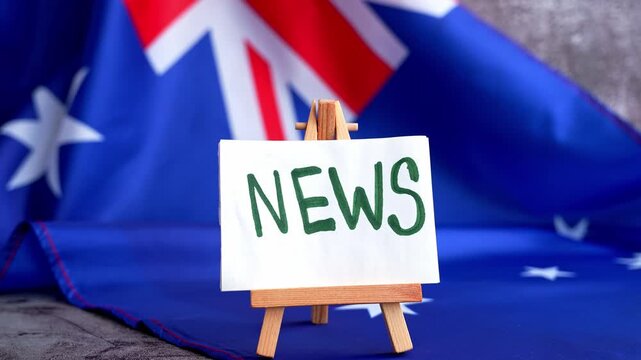 Flag-themed board with NEWS text for media headlines. Patriotic mockup with text NEWS Vibrant Australian flag background trending for current affairs content. Concept of national reporting and media