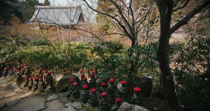 Old Jizo Statues with Red Hats in Japanese Temple Garden In Hiroshima - Slow, Steady Cam Shot