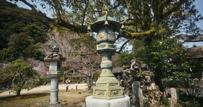 Ancient Bronze Lantern and Stone Monuments at Japanese Shrine In Hiroshima - Slow, Steady Cam Forward Shot