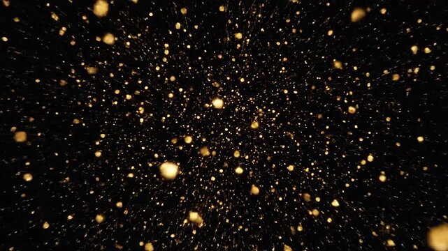 Golden sparks and glowing particles explode on a black background