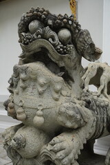 Fototapeta premium Ancient stone lion statue guarding a temple entrance with intricate details