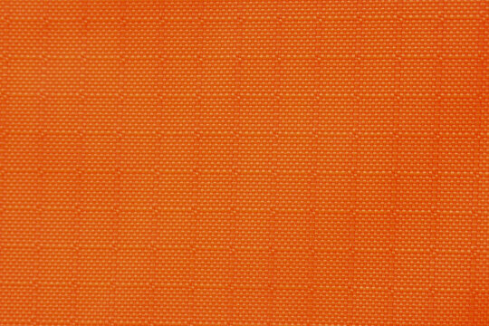 Orange fabric textile pattern texture background woven grid closeup material seamless design create vibrant and energetic mood for upholstery or fashion projects