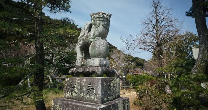 Old Stone Komainu Guardian Statue at Japanese Shrine In Hiroshima - Slow Steady Cam Shot