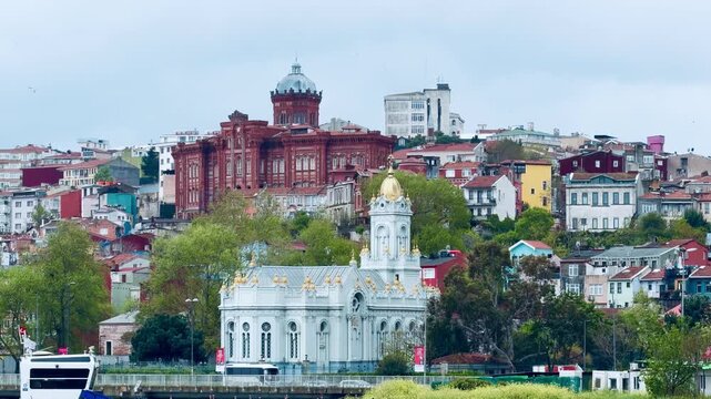 Historic Bulgarian St Stephen Iron Church and Phanar Greek College on Golden Horn coast in Istanbul, Turkey. Ancient orthodox landmarks, old town Balat district architecture and Bosphorus background.