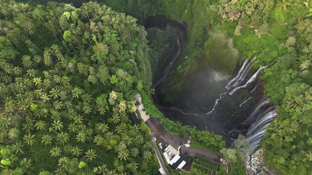 High angle view of Tumpak Sewu waterfall is one of the most stunning waterfalls in Indonesia, standing at 120 meters tall with the most insane panorama view.