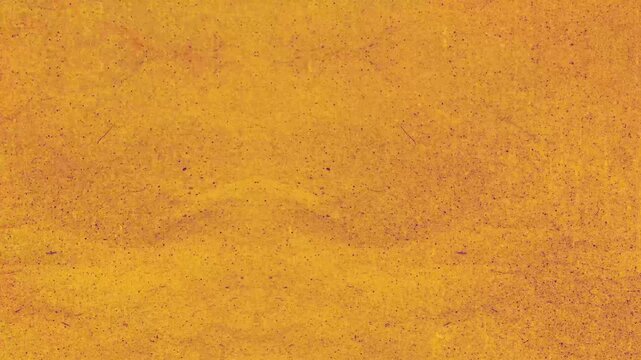Grunge background fine grainy texture orange surface colored powder particles bright golden mustard hue. Suitable for food, cosmetics, and abstract backgrounds.