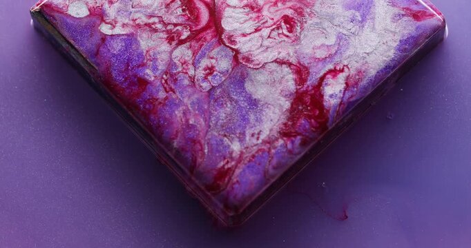 Splatter paint. Geometric abstract background. Defocused purple red silver color ink cube glass angle bubbles floating on acrylic art.