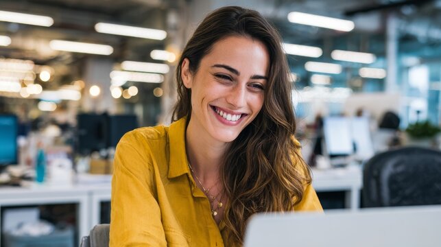 97.Professional woman working on a laptop in a bright open office, smiling despite project challenges, candid business lifestyle scene