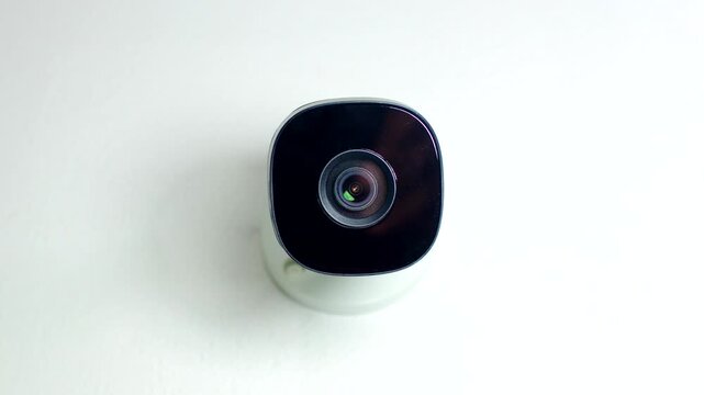 Effective Surveillance: CCTV security camera mounted on a white wall, ensuring protection and continuous monitoring.