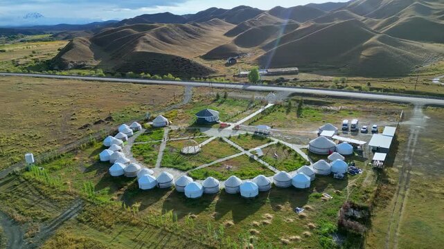 Yurt Camping Panorama. Drone Captures Extensive Scenic Landscape Featuring Yurts Arranged In Circle