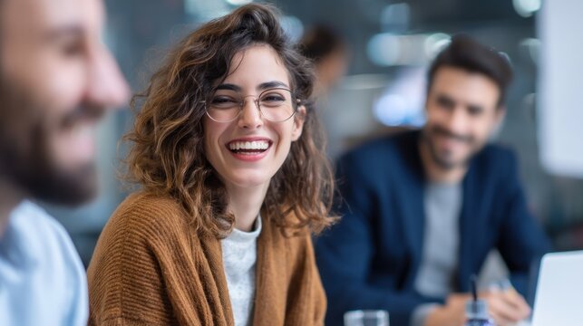 Woman laughing at business meeting