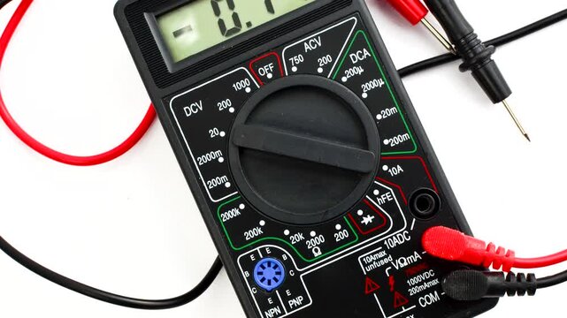 Close-up of a multimeter on a clear surface, highlighting precision and versatility for electrical measurements.