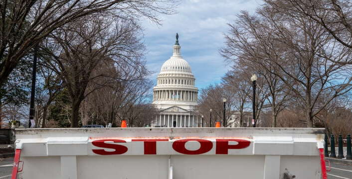 Stop barricade near Capitol landmark. Government shutdown issue in Washington DC. Security restriction at Capitol Hill entrance. Budget stalemate and political tension.