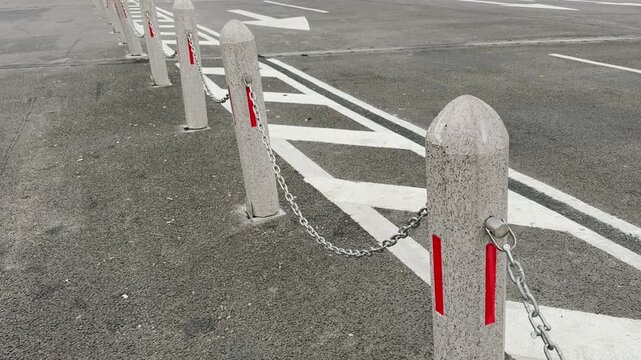Row of Concrete Bollards with Chains and Restricted Zone Road Markings