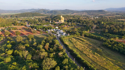 Obraz premium Aerial View of Giant Golden Buddha Statue in Khao Yai Landscape