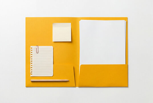 Open yellow presentation folder with blank white papers and pen