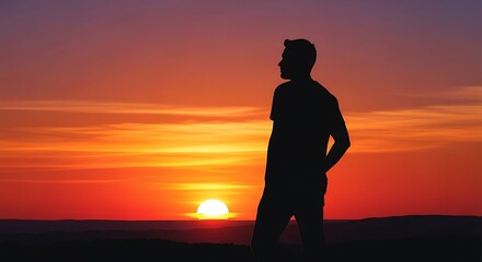 Fototapeta premium Silhouette of person watching sunset over water.