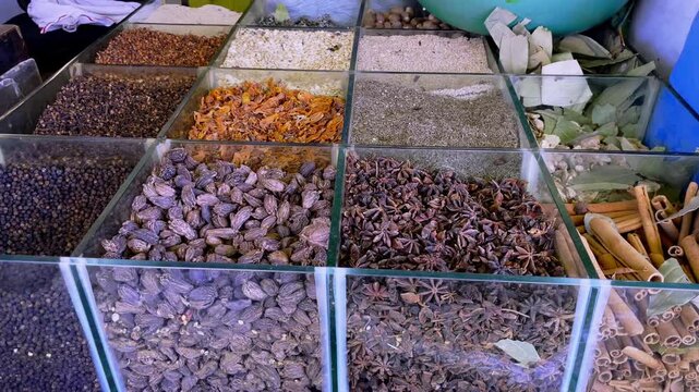 Close up view of assorted Indian spices displayed in glass containers at a traditional market store in Indore Madhya Pradesh India showcasing ingredients used in Indian cooking and spice trade.