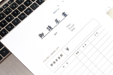 請求書 - 取引先へ宛てて請求書を準備する、ビジネスシーンのイメージ  © PJM