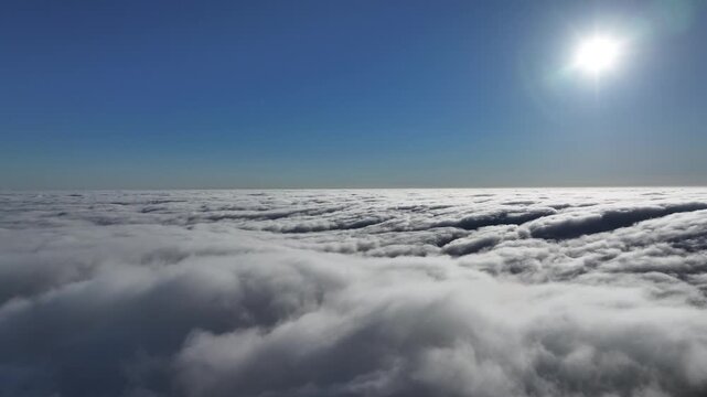 Moving cloud layer provides a mesmerizing effect with striking contrast between white, blue and sun, moving at a steady pace