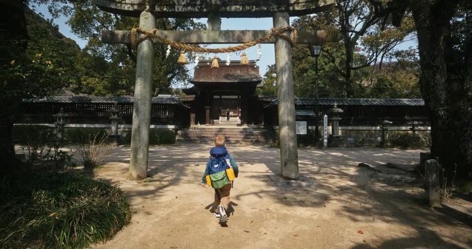 Child Walking Toward Torii Gate at Japanese Shinto Shrine - Steady Cam Shot