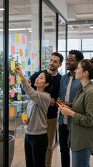 Obraz premium Startup team brainstorming with blank sticky notes on a glass wall