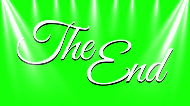 The End text sits in white cursive letters on a green screen background with two bright spotlights shining from the top corners of the frame.