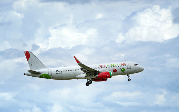 Viva Airline aircraft, Airbus A320, approaching Dallas Fort Worth International Airport. Storm clouds.