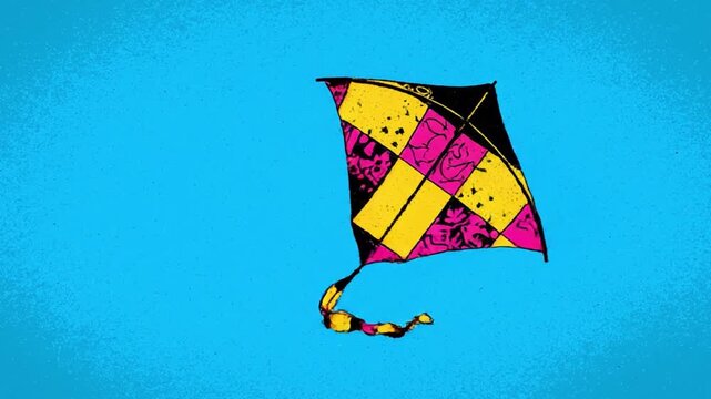Vibrant colorful kite flying high in a clear blue sky with yellow pink and black patterns