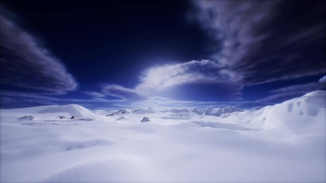 Cinematic aerial footage of vast snowy mountain landscape under dramatic cloudy sky.