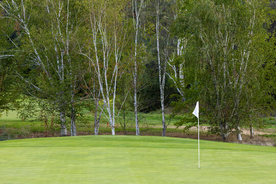 Golf course with white flag in hole on green, Bright Victoria Australia