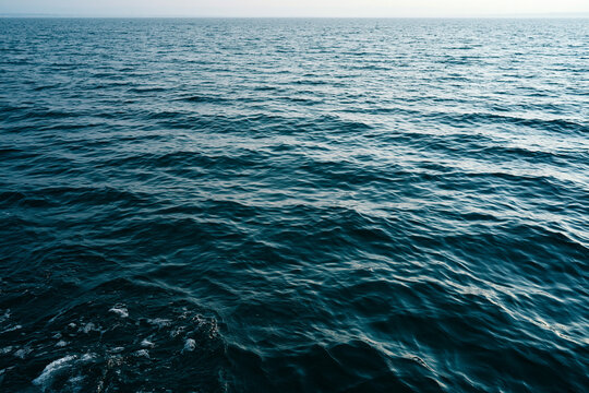 Waves move on the surface of the ocean at sunset
