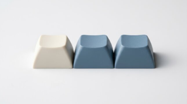 Three blank mechanical keyboard keycaps isolated on white background