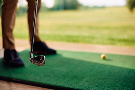 Close up of golf player during golf practice at driving range.