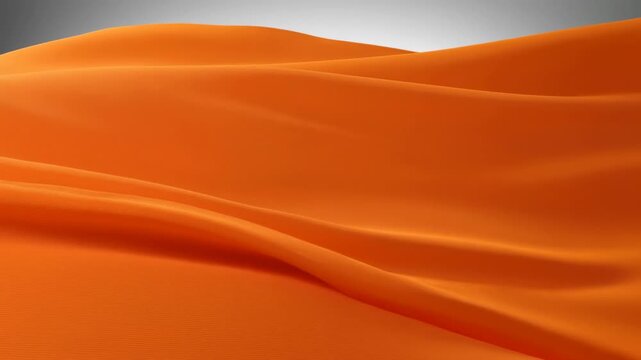 Close-up of draped orange silk fabric with soft folds
